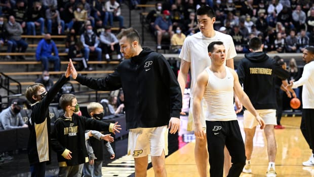 Sasha Stefanovic high fives a young fan before the Purdue, Nicholls State game at home.